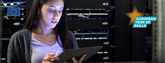 Woman working on a tablet in server room